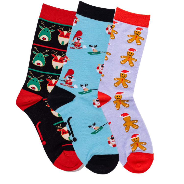 Three pairs of Christmas-themed socks with reindeer, Skiing Santa Claus, and gingerbread men 
