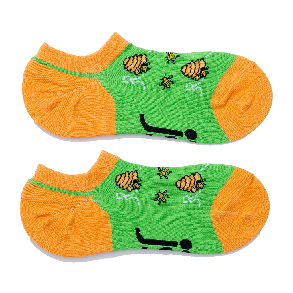 A pair of low-cut socks with bright green sides and orange toes, heels, and soles featuring a bee & hive design.