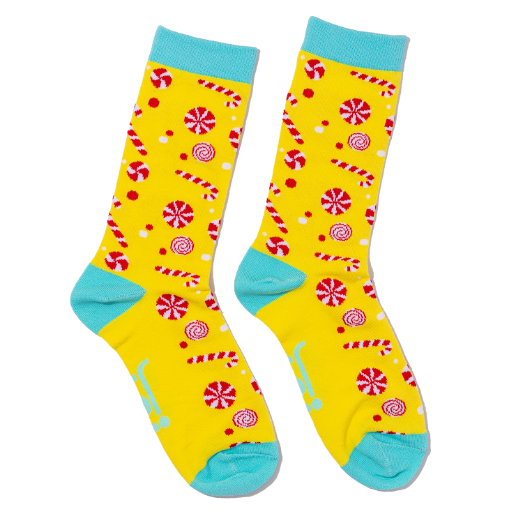 Colorful socks with candy cane and peppermint pattern on a yellow background
