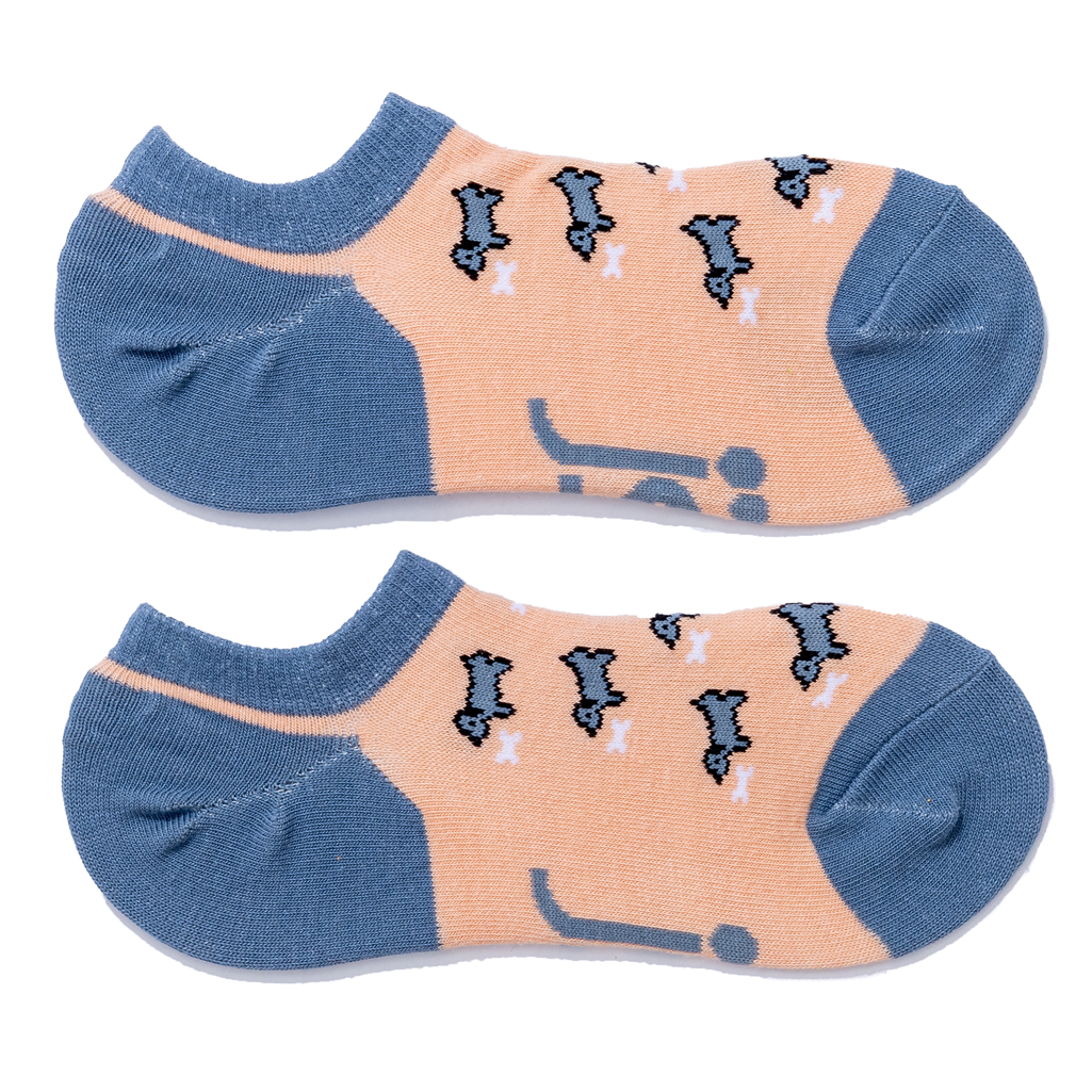 A pair of low-cut ankle socks with a peach-colored foot body & blueish grey heel & toes with a sausage dog pattern