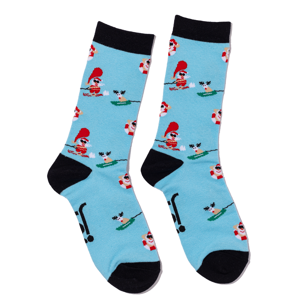 Pair of socks with santa & reindeer water skiing pattern on a light blue background