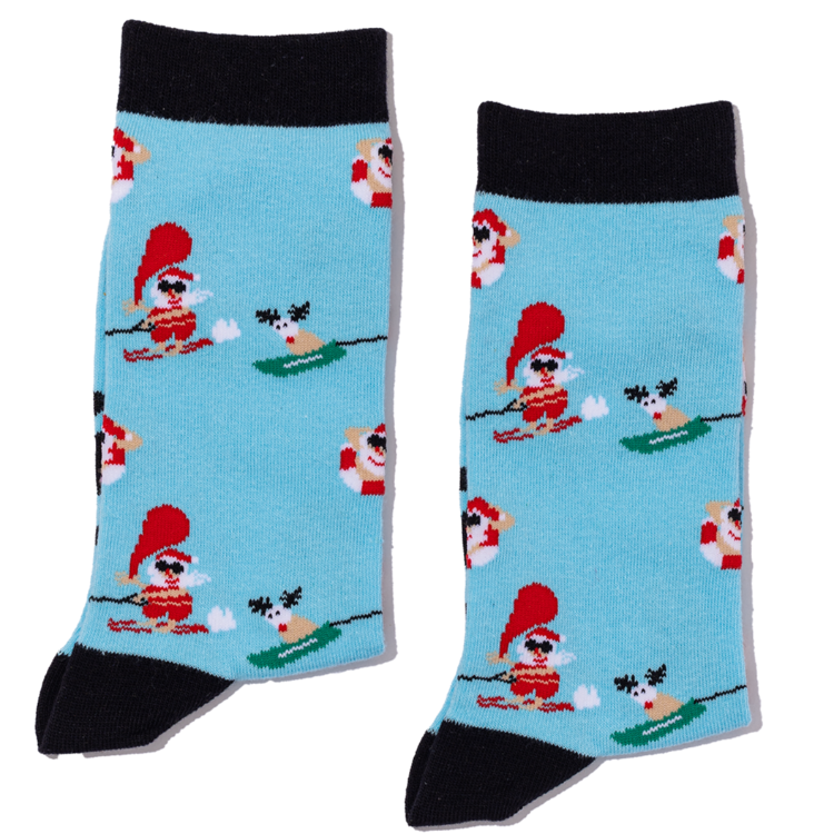 Pair of socks with waterskiing santa & reindeer design on a light blue background